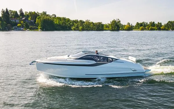 Slide: The Image of 2022 Fairline F//Line 33 yacht cruising on a serene lake with lush green surroundings. - 0