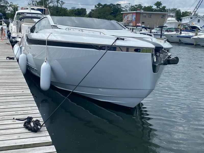 Slide: The Image of 2022 Fairline F//Line 33 yacht docked at a marina, showcasing sleek design and modern features. - 1