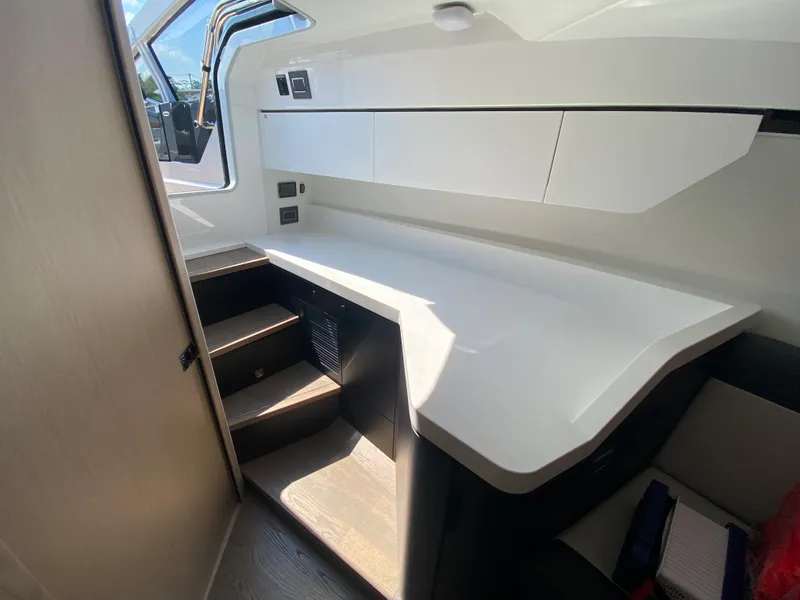 Slide: The Image of Interior of 2022 Fairline F//Line 33 yacht with modern white cabinetry and stairs. - 13