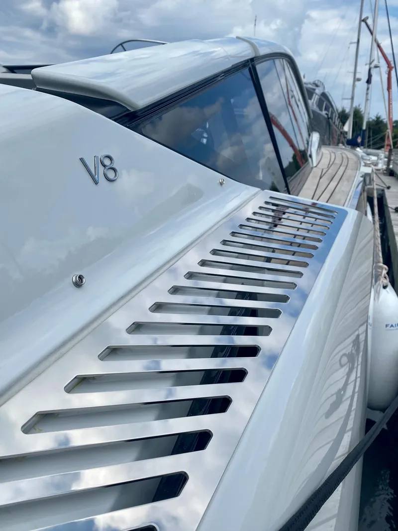 Slide: The Image of 2022 Fairline F//Line 33 yacht with V8 engine, sleek design, docked under cloudy sky. - 4