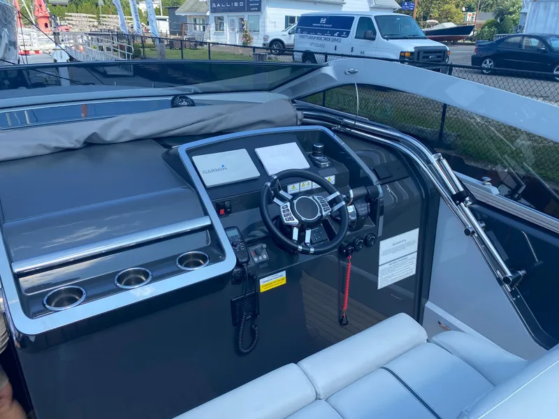 Slide: The Image of 2022 Fairline F//Line 33 cockpit with modern steering and control panel. - 5