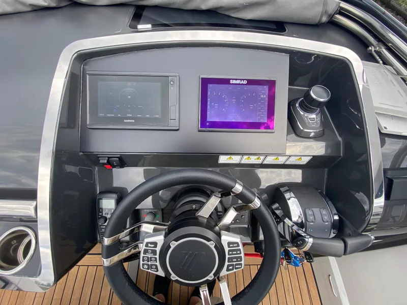 Slide: The Image of Helm of 2022 Fairline F//Line 33 yacht with modern navigation controls and displays. - 6