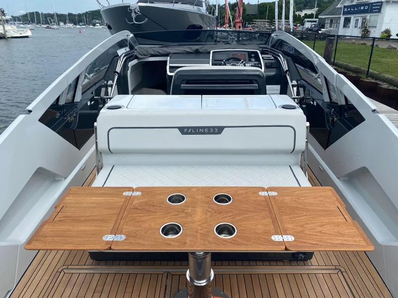 Slide: The Image of 2022 Fairline F//Line 33 yacht interior with wooden table and sleek design. - 8