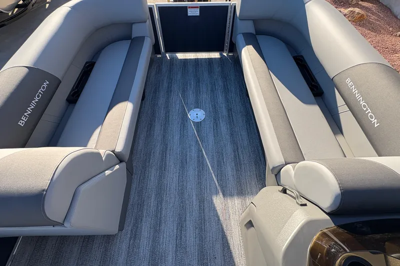 Slide: The Image of 2026 Bennington 21 SSR boat interior with gray seating and carpeted flooring. - 11