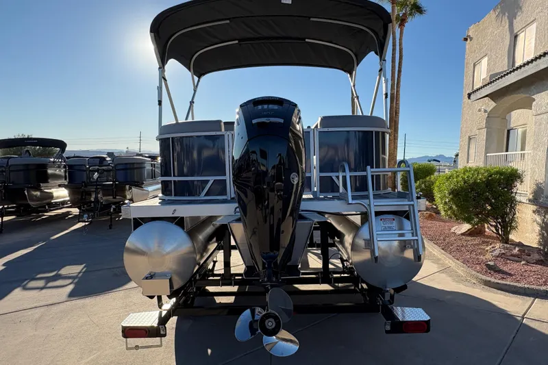 Slide: The Image of 2026 Bennington 21 SSR pontoon boat with outboard motor and canopy in a sunny setting. - 5