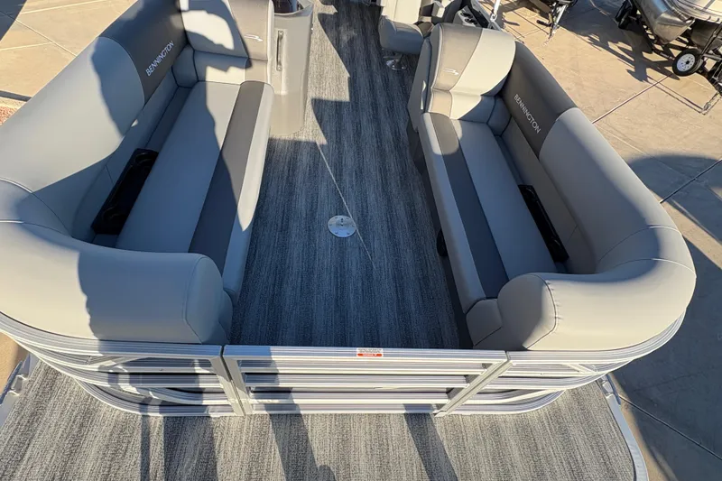 Slide: The Image of 2026 Bennington 21 SSR pontoon boat interior with gray seating and carpeted floor. - 7