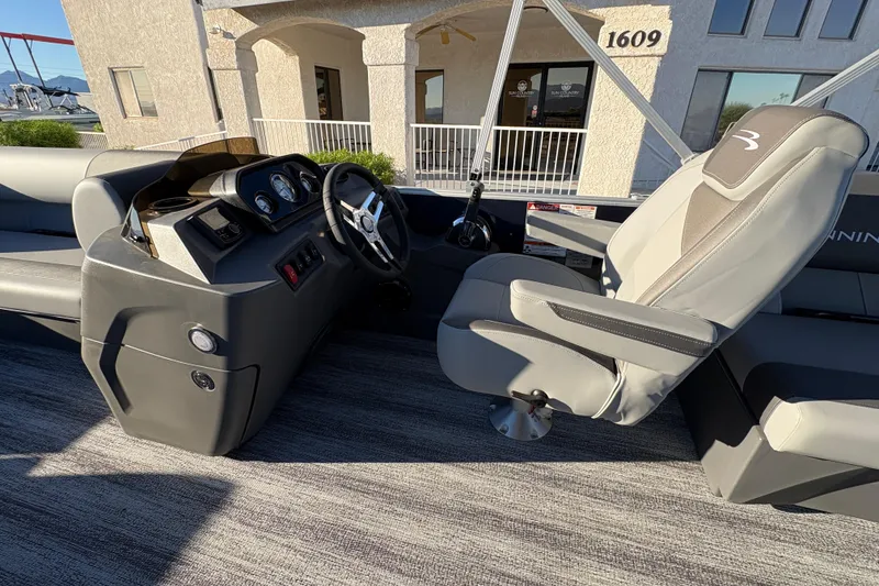 Slide: The Image of 2026 Bennington 21 SSR boat interior with steering console and captain's chair. - 8