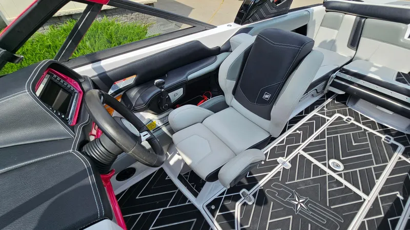 Slide: The Image of 2015 Nautique Super Air G23 interior with modern steering and seating design. - 15