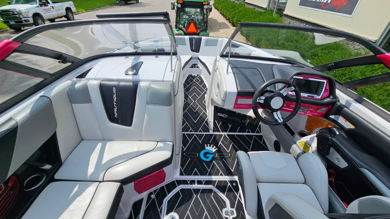 Slide: The Image of 2015 Nautique Super Air G23 boat interior with sleek seating and modern dashboard. - 17