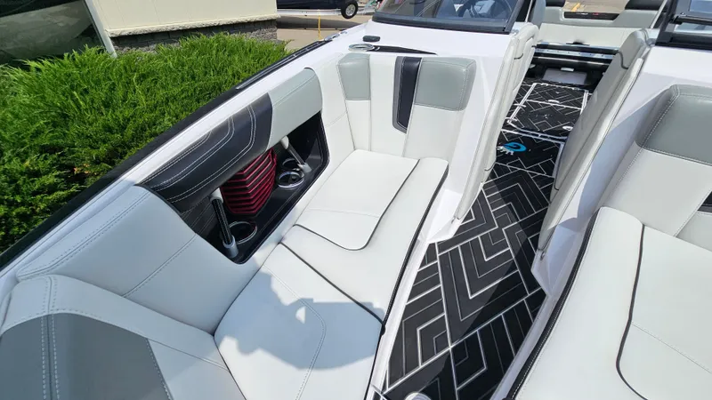 Slide: The Image of 2015 Nautique Super Air G23 interior with sleek gray seating and geometric flooring design. - 21
