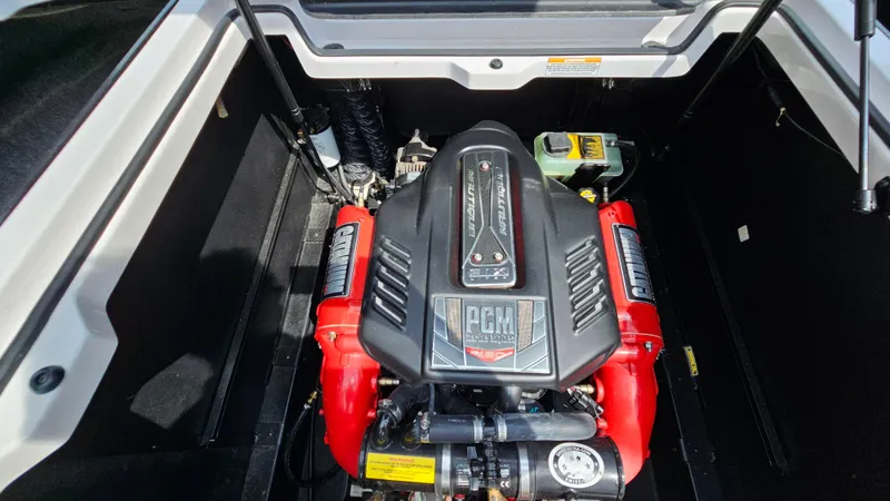 Slide: The Image of Engine compartment of a 2015 Nautique Super Air G23 boat, featuring a PCM engine. - 27