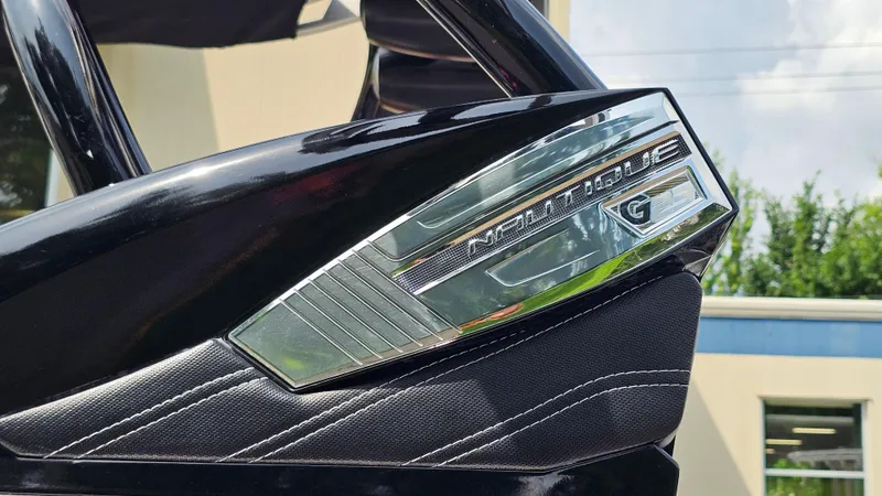 Slide: The Image of 2015 Nautique Super Air G23 boat detail with chrome logo and stitching. - 35