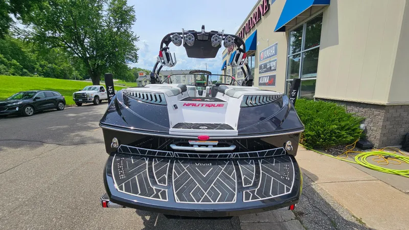 Slide: The Image of 2015 Nautique Super Air G23 boat parked outside a marine dealership. - 5