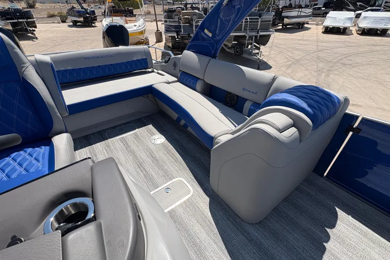 Slide: The Image of Luxurious interior of 2026 Bennington 27 RXSBAT2 boat with blue and gray seating. - 11