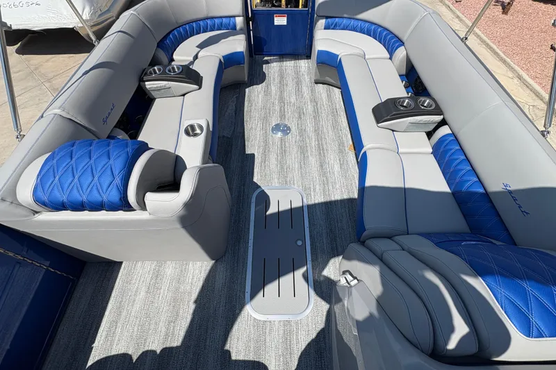 Slide: The Image of Luxurious interior of 2026 Bennington 27 RXSBAT2 pontoon boat with blue and gray seating. - 12