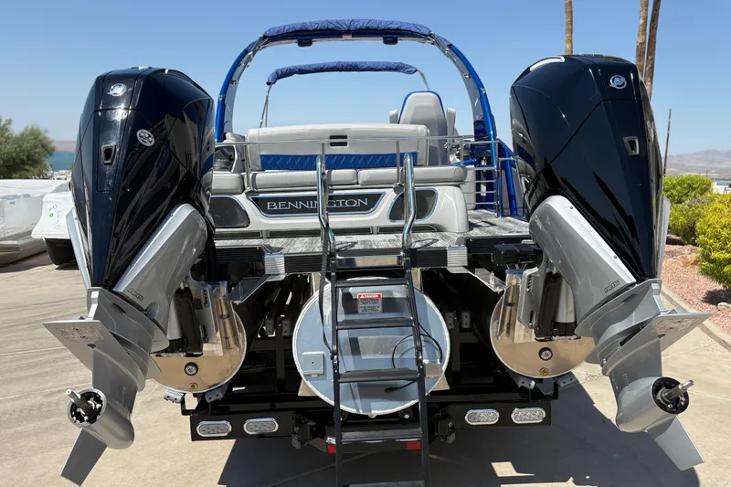 Slide: The Image of 2026 Bennington 27 RXSBAT2 boat with dual outboard motors, rear view. - 14