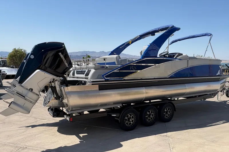 Slide: The Image of 2026 Bennington 27 RXSBAT2 pontoon boat with Mercury outboard engine on trailer. - 2