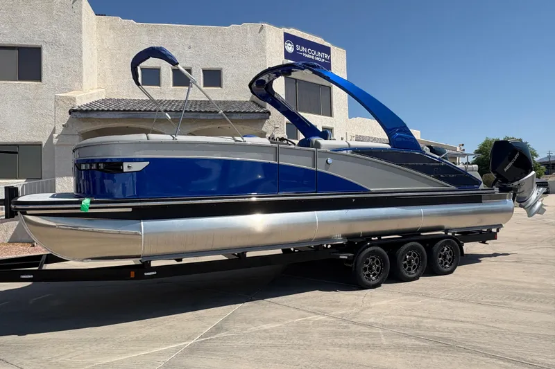 Slide: The Image of 2026 Bennington 27 RXSBAT2 pontoon boat on trailer, blue and silver design. - 3
