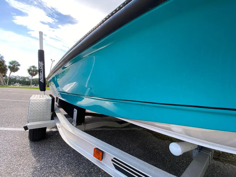 Slide: The Image of 2023 Action Craft 1720 Flats Gen 3 boat on trailer, vibrant blue hull, sunny day. - 11