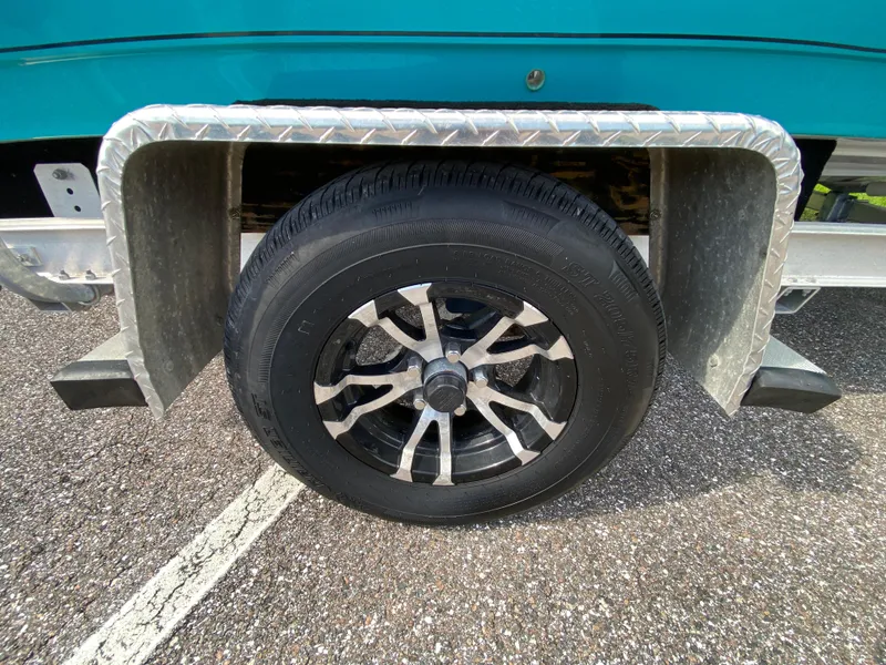 Slide: The Image of Trailer wheel of 2023 Action Craft 1720 Flats Gen 3 boat on asphalt. - 13