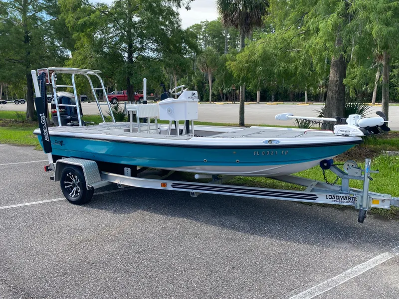 Slide: The Image of 2023 Action Craft 1720 Flats Gen 3 boat on trailer in parking lot. - 2