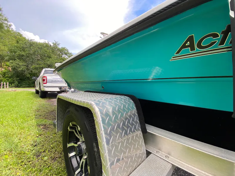 Slide: The Image of 2023 Action Craft 1720 Flats Gen 3 boat on trailer, parked near a truck. - 27