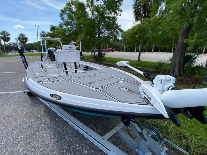 Slide: The Image of 2023 Action Craft 1720 Flats Gen 3 boat on trailer, parked near trees. - 30