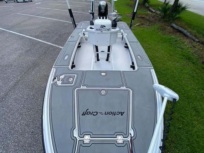 Slide: The Image of 2023 Action Craft 1720 Flats Gen 3 boat with sleek deck design in parking area. - 42