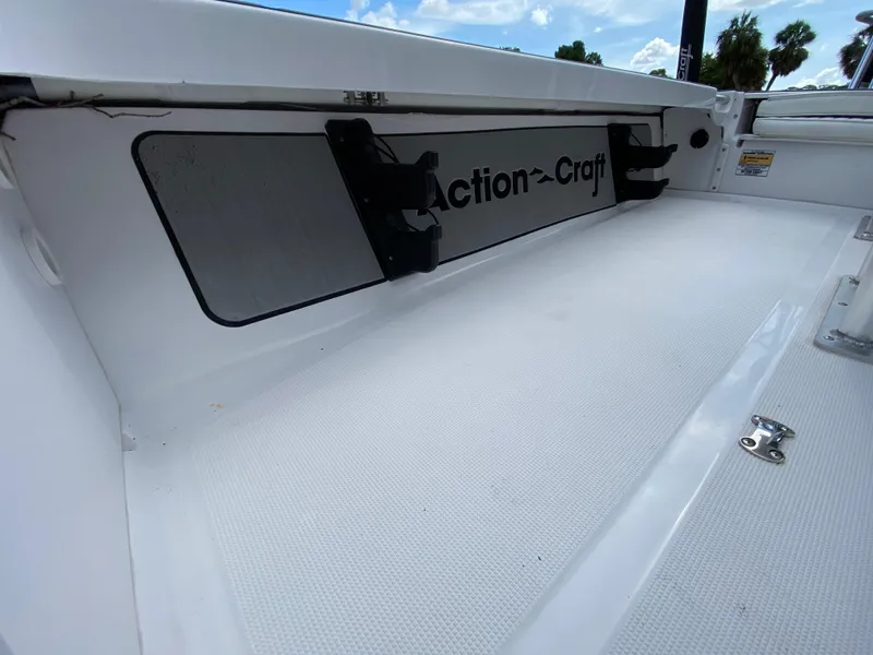 Slide: The Image of 2023 Action Craft 1720 Flats Gen 3 boat interior with branding and storage features. - 44