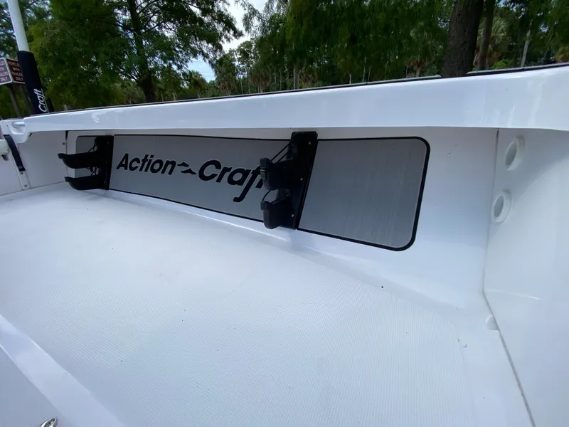 Slide: The Image of 2023 Action Craft 1720 Flats Gen 3 boat interior with logo and rod holders. - 45