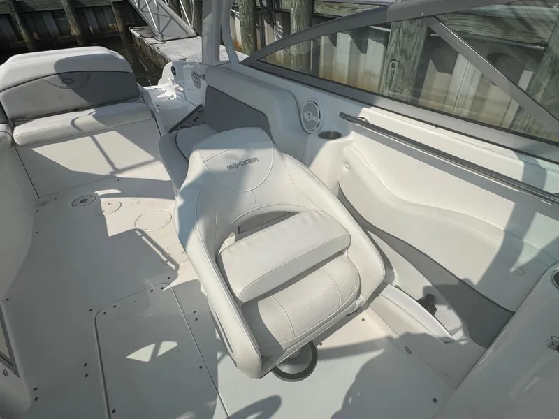Slide: The Image of 2013 Rinker 296 Captiva Bowrider interior with white seating and helm area. - 13
