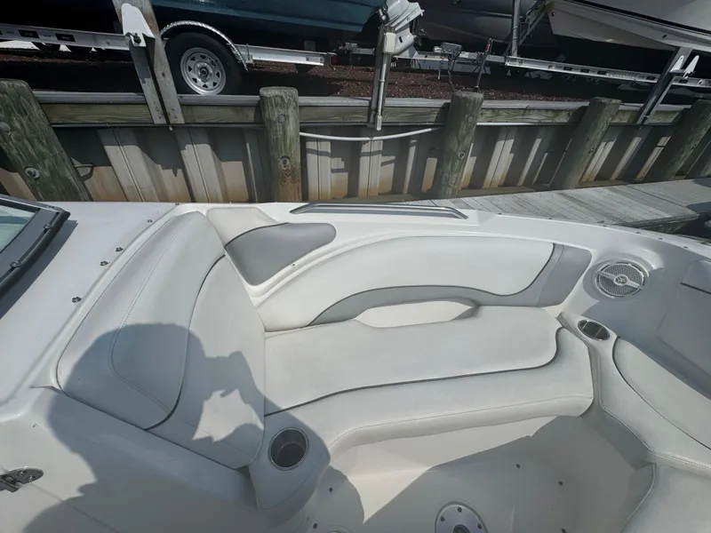 Slide: The Image of 2013 Rinker 296 Captiva Bowrider interior with white seating and cup holders. - 16