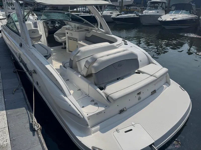 Slide: The Image of 2013 Rinker 296 Captiva Bowrider docked, featuring spacious seating and sleek design. - 2