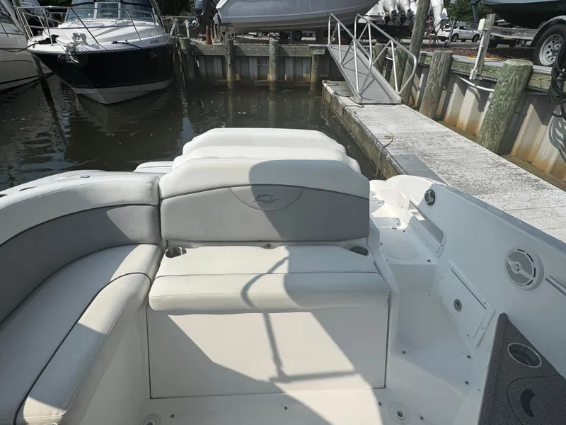 Slide: The Image of 2013 Rinker 296 Captiva Bowrider interior with seating, docked at marina. - 4