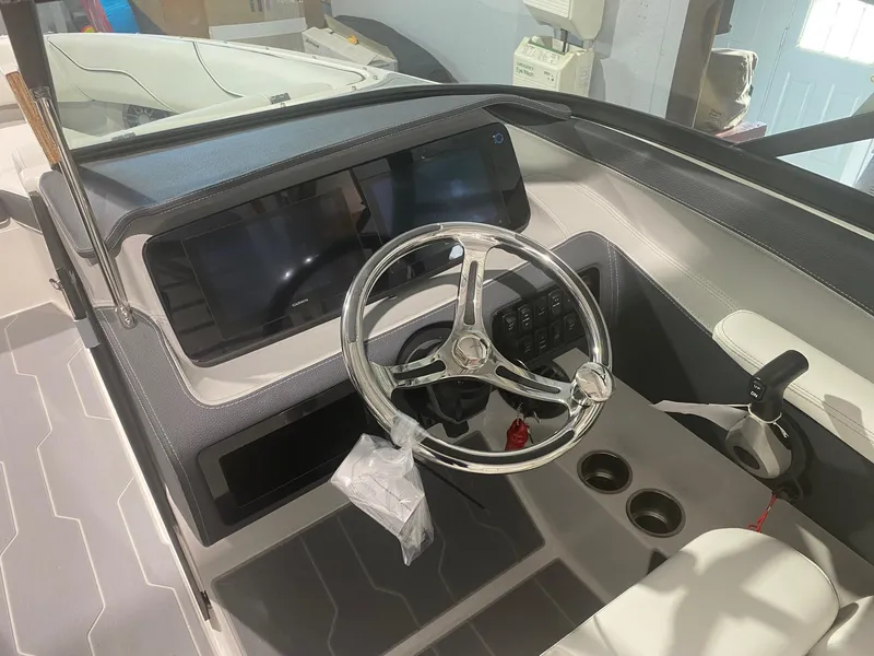 Slide: The Image of 2024 Regal LX4 boat dashboard with steering wheel and digital displays. - 10
