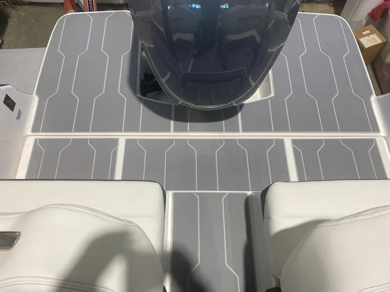 Slide: The Image of 2024 Regal LX4 boat deck with gray non-slip flooring and white seating. - 8