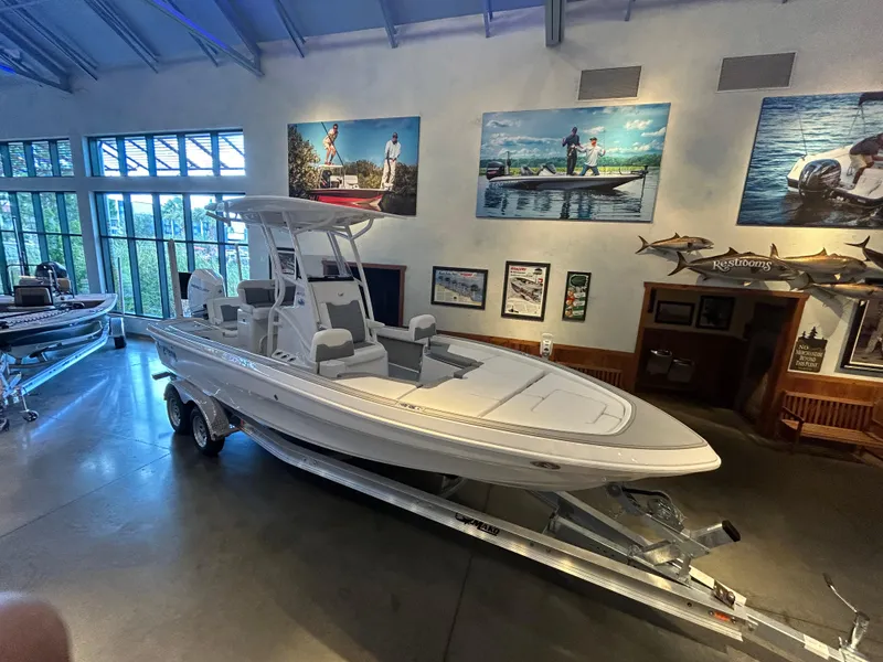 The Image of 2025 Mako 24 APEX boat displayed indoors on a trailer. - 0