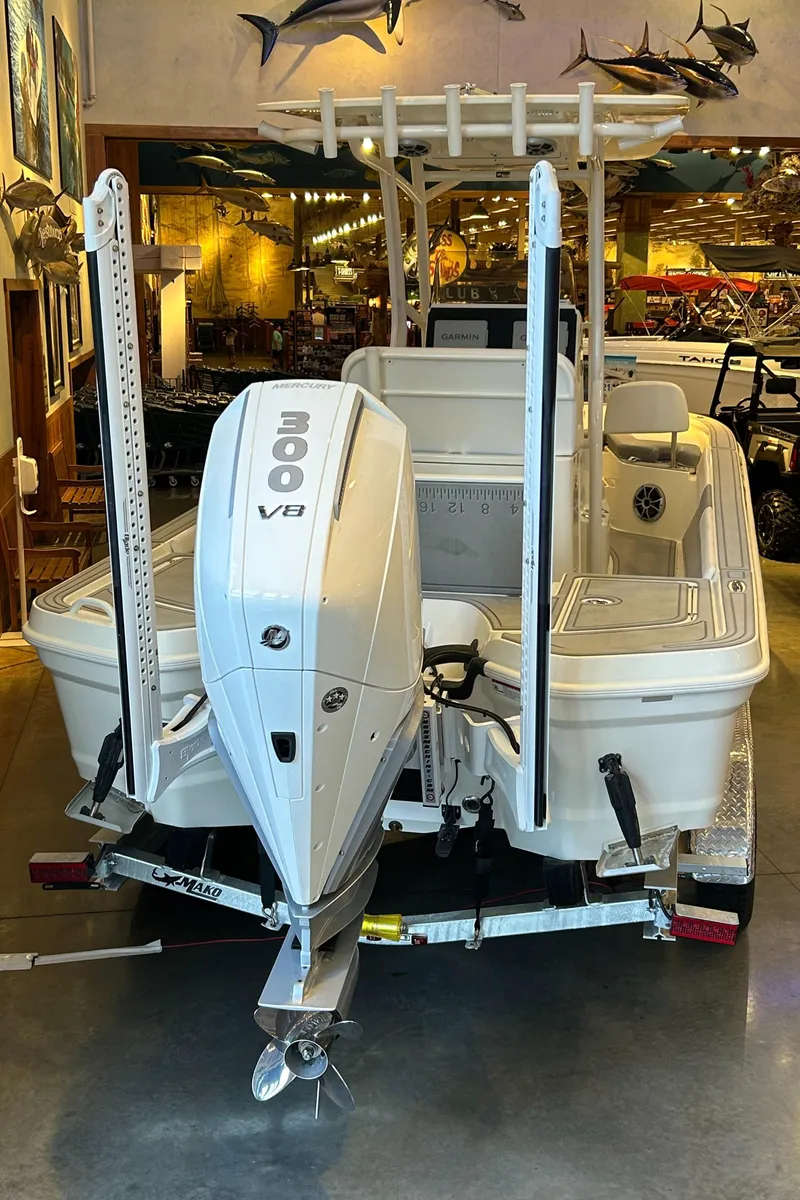 Slide: The Image of 2025 Mako 24 APEX boat with 300 V8 engine displayed indoors. - 4