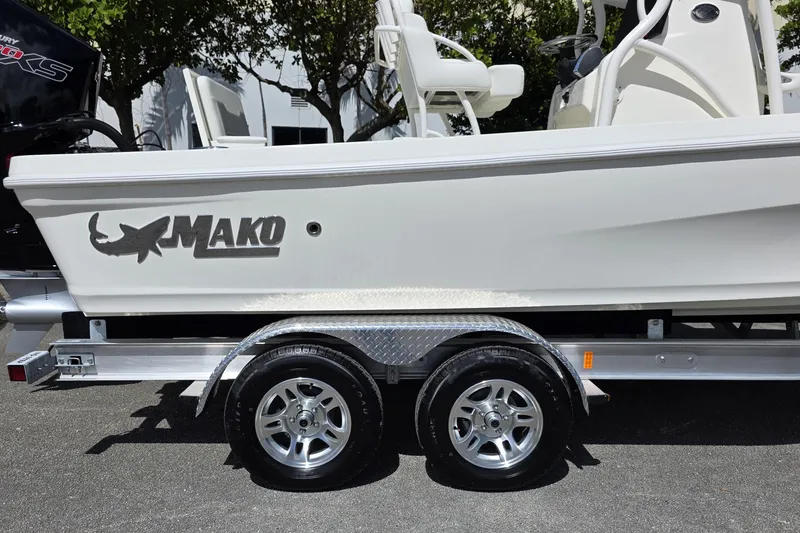 Slide: The Image of 2025 Mako 24 APEX boat on trailer, side view with logo visible. - 17