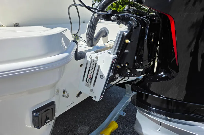 Slide: The Image of 2025 Mako 24 APEX boat engine mount detail with hydraulic components. - 18
