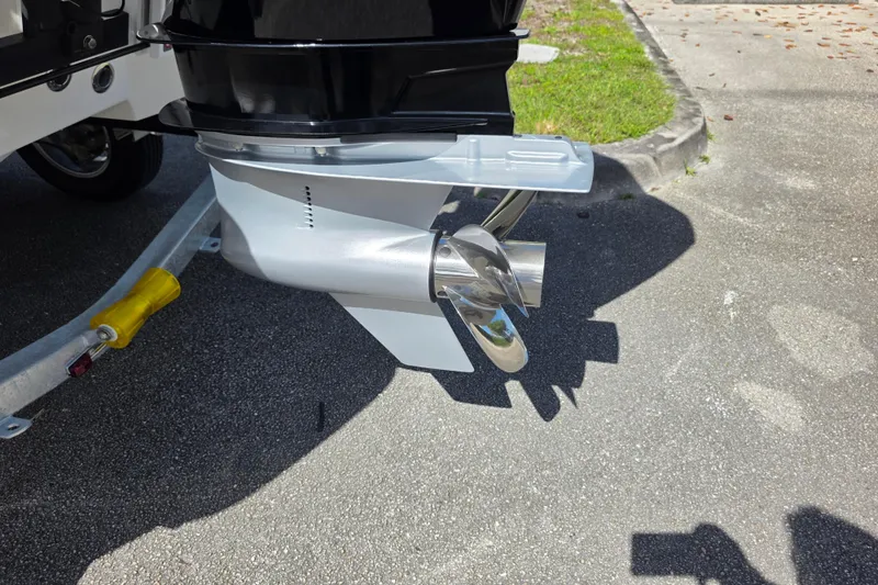 Slide: The Image of Outboard motor propeller of 2025 Mako 24 APEX boat on a trailer. - 21