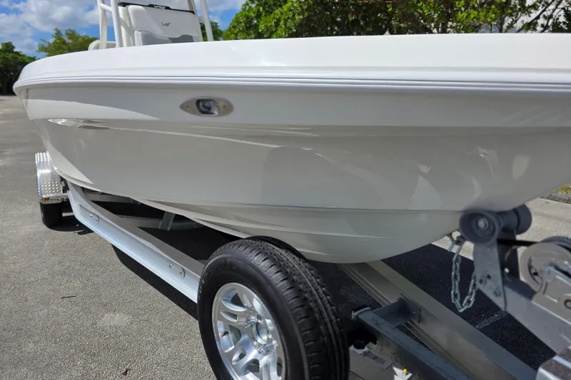 Slide: The Image of 2025 Mako 24 APEX boat on trailer, showcasing sleek design and modern features. - 22