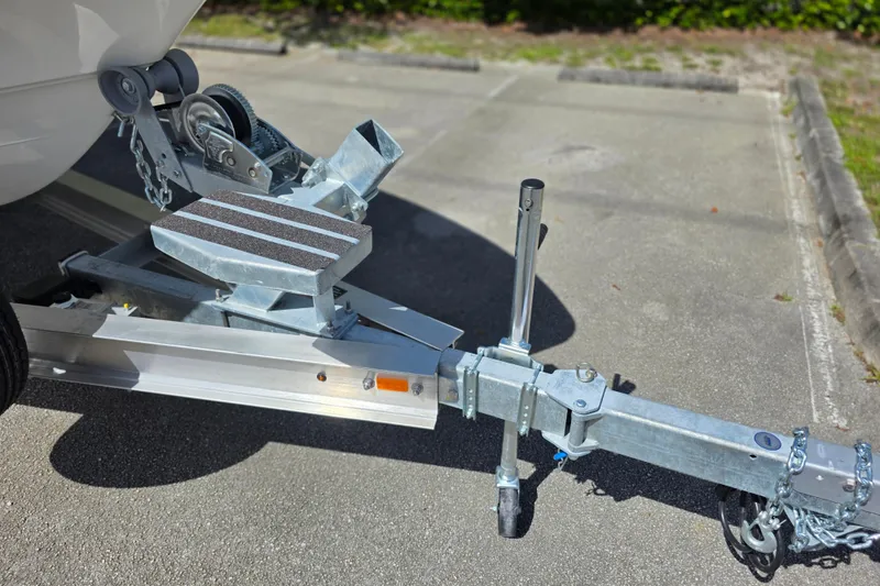 Slide: The Image of Trailer hitch of 2025 Mako 24 APEX boat on pavement. - 23