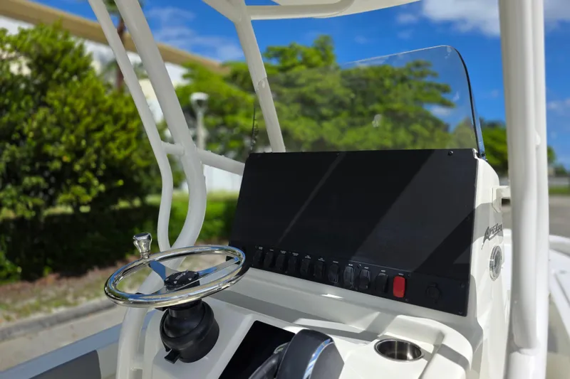 Slide: The Image of 2025 Mako 24 APEX boat console with steering wheel and control panel. - 6
