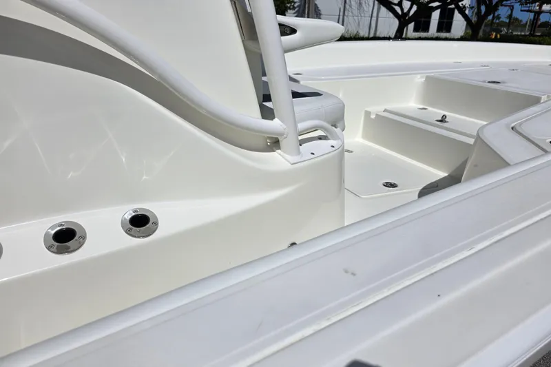 Slide: The Image of Interior view of 2025 Mako 24 APEX boat, showcasing seating and storage compartments. - 9