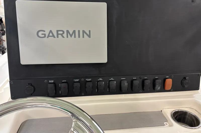 Slide: The Image of Control panel of 2025 Mako 24 APEX boat with Garmin navigation system. - 26