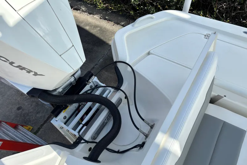 Slide: The Image of 2025 Mako 24 APEX boat with Mercury engine, featuring sleek seating and modern design. - 17