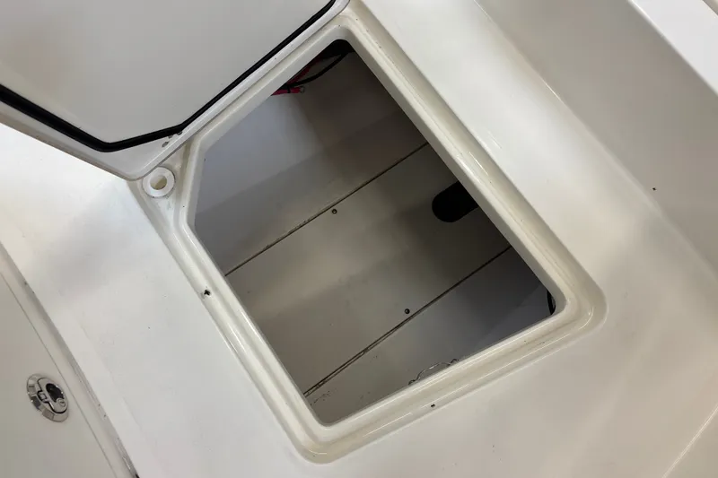 Slide: The Image of Open storage compartment on 2025 Mako 24 APEX boat, showcasing interior space. - 40