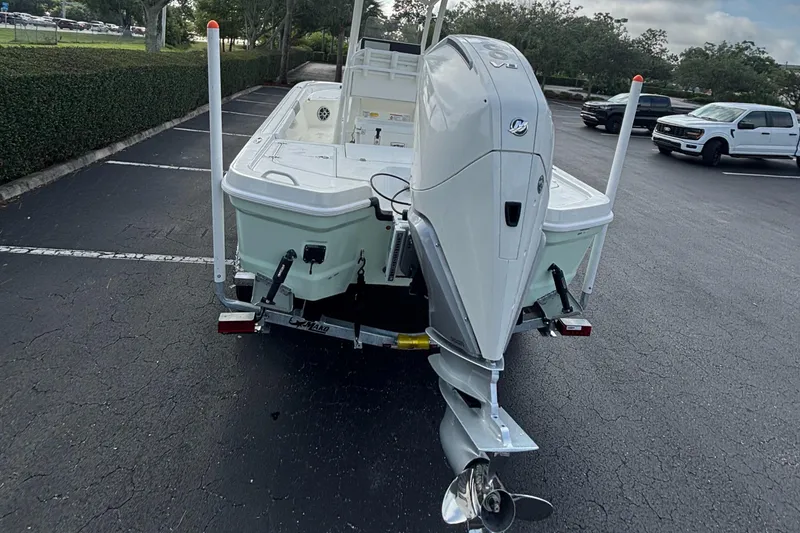 Slide: The Image of 2025 Mako 24 APEX boat on trailer in parking lot, rear view. - 3