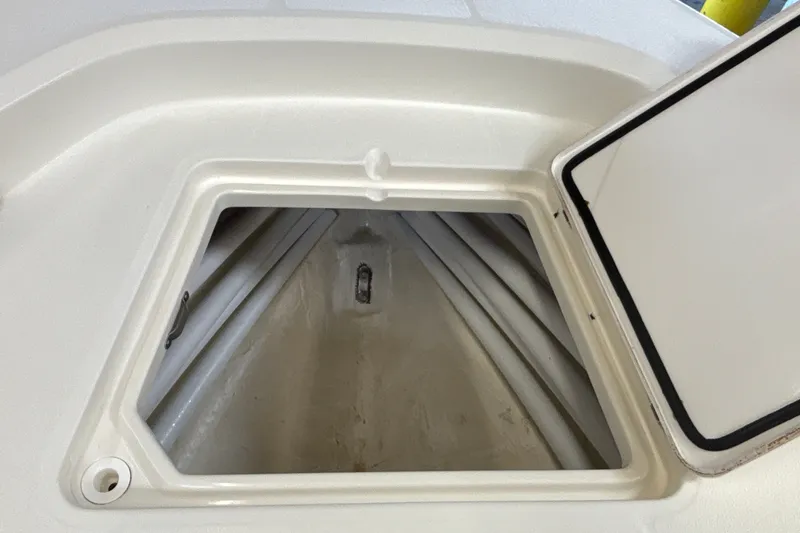 Slide: The Image of Open storage compartment on 2025 Mako 24 APEX boat, showcasing interior space. - 43